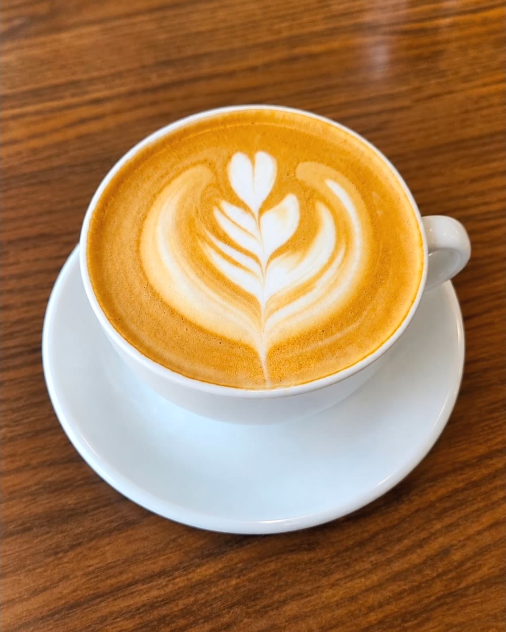 A flat white with tulip latte art at Thrive coffee shop